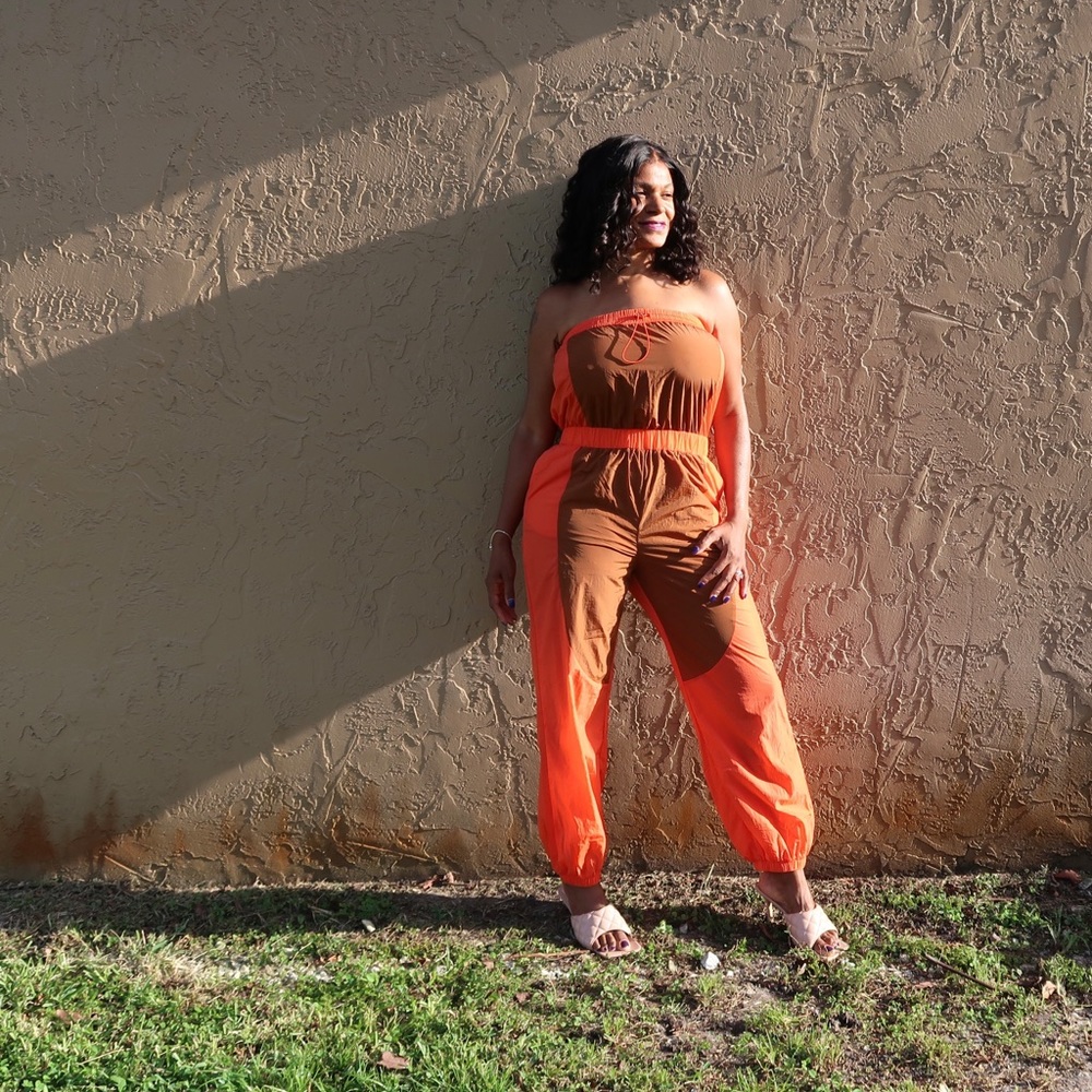 Halter jumpsuit new never worn. Wind breaker material can be worn with heels.